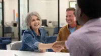 Woman shaking hand in branch