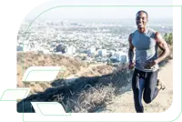 Young adult male in performance athletic wear running on a California hillside