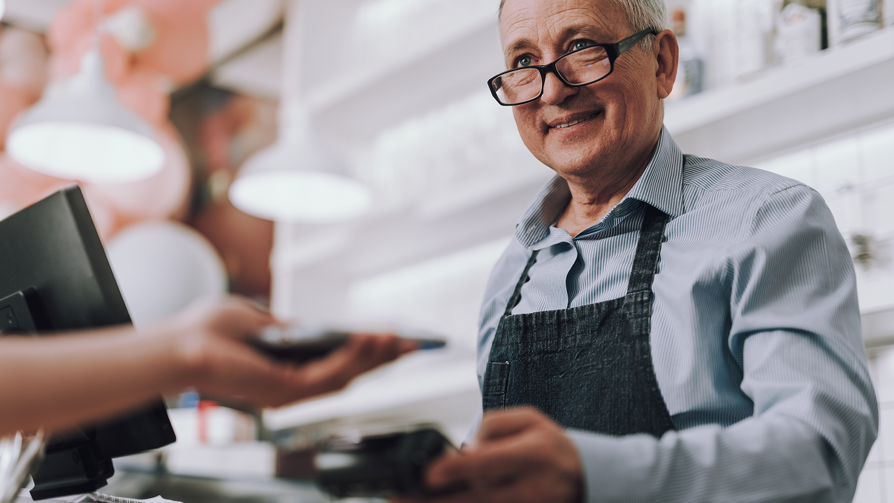 Shopkeeper accepting tap payment