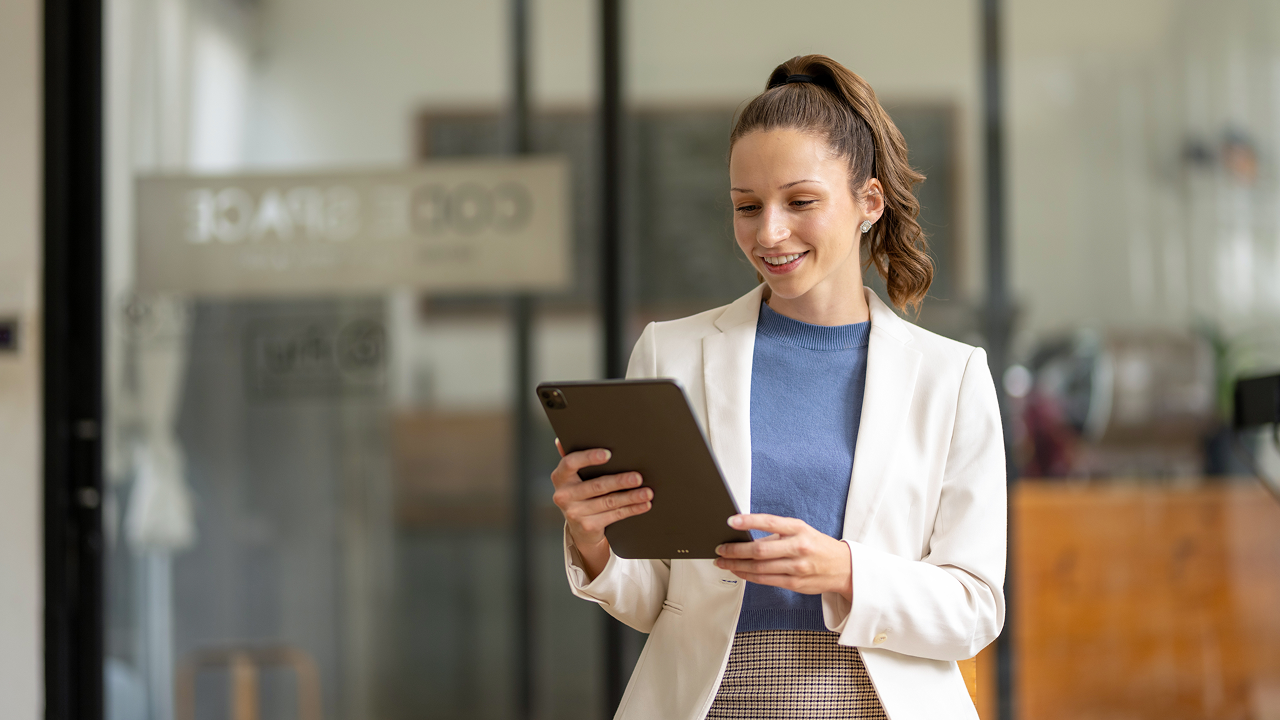 Woman in spring suit with tablet